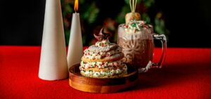 Holiday cookie tree next to candles and hot cocoa at Planet Hollywood NYC