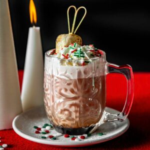 A huge glass mug full of hot cocoa